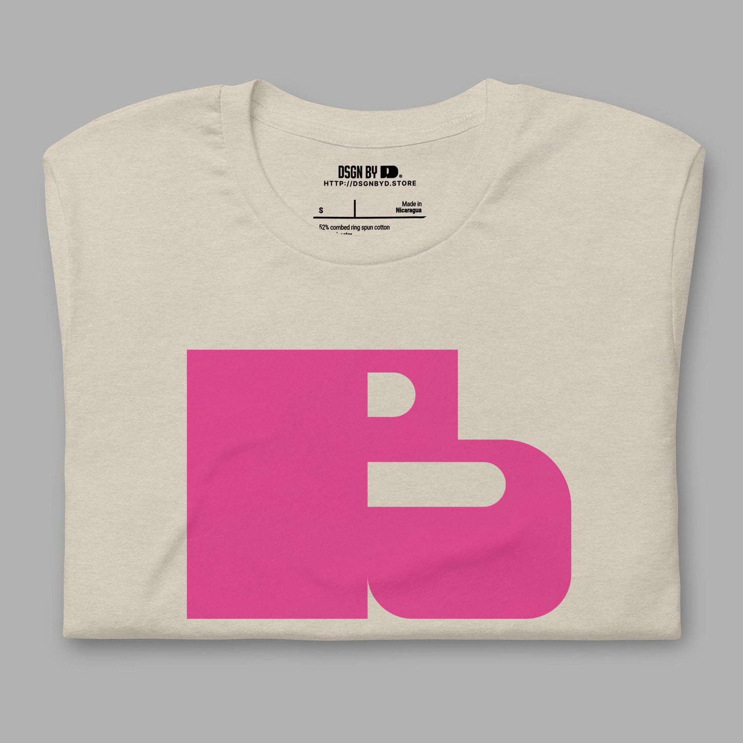 A folded beige cotton unisex graphic tee with letter B.