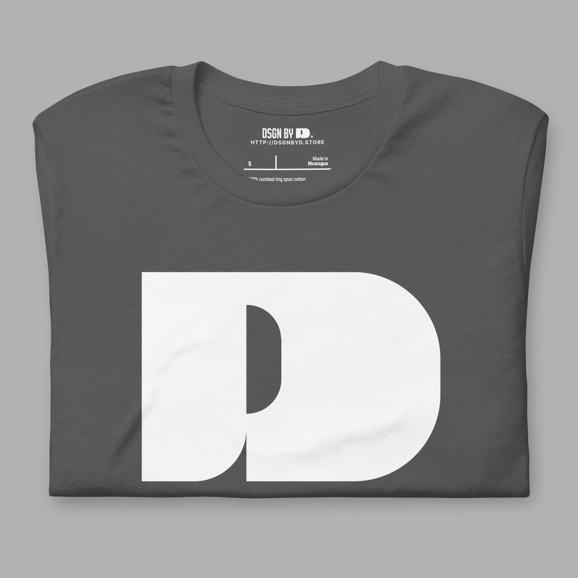 A folded grey cotton unisex graphic tee with letter D .