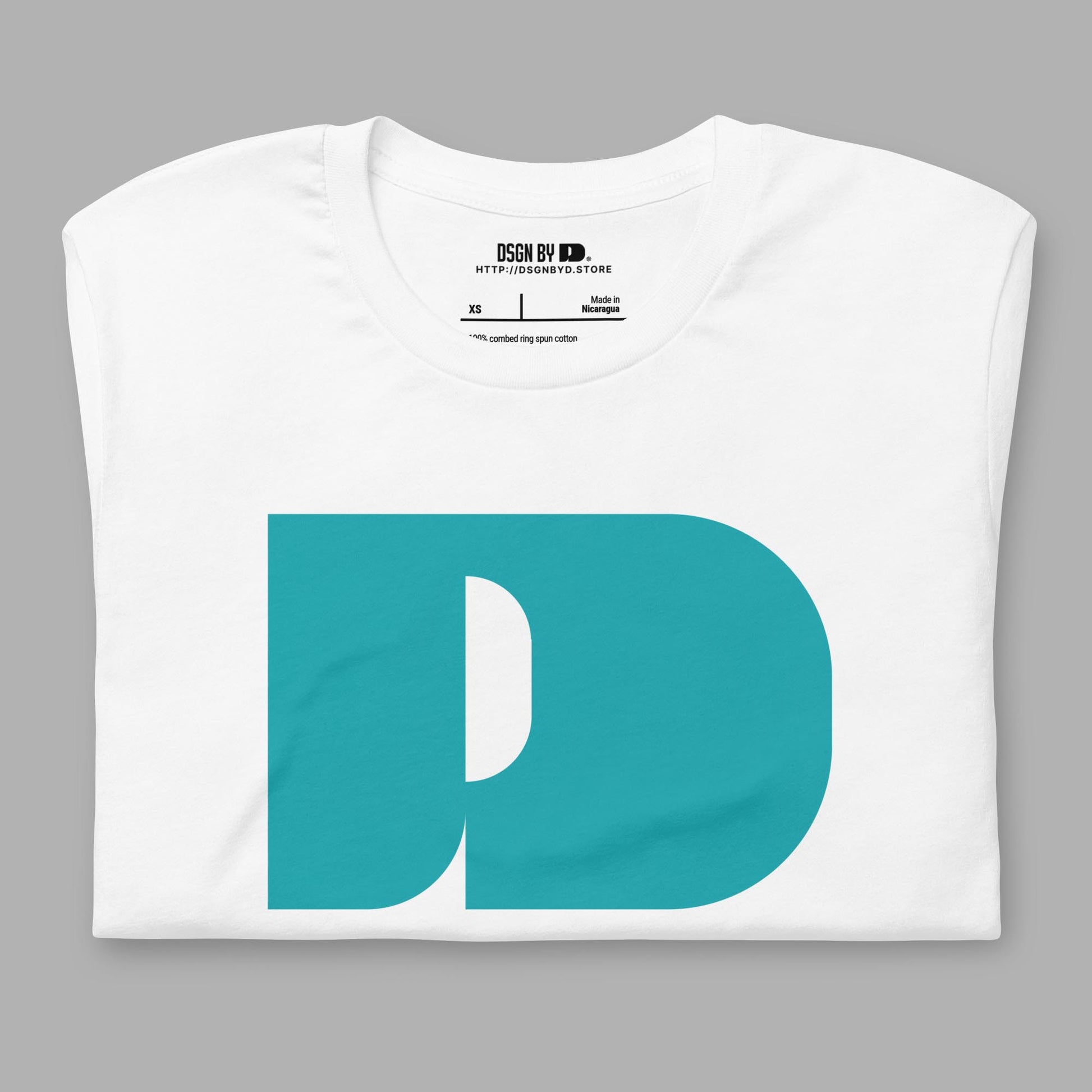 A folded white cotton unisex graphic tee with letter D .