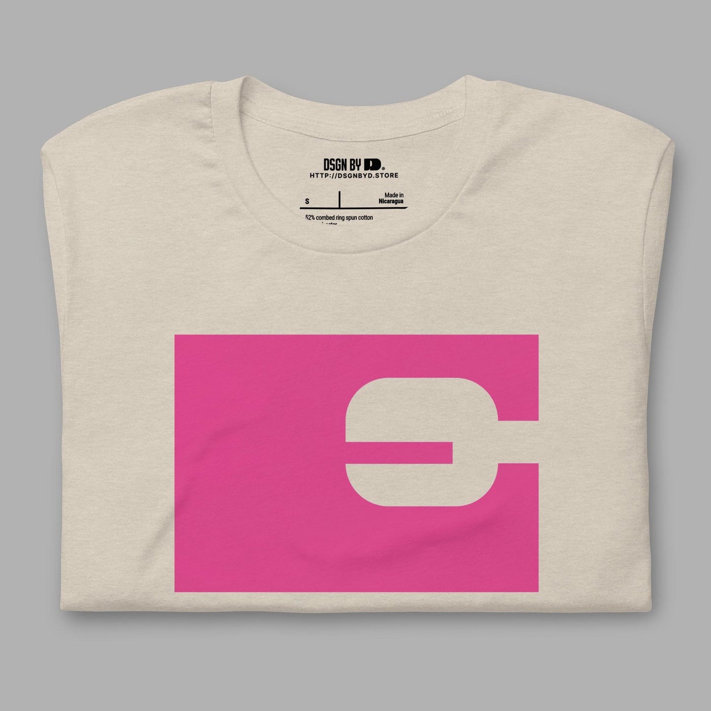 A folded beige cotton unisex graphic tee with letter E.