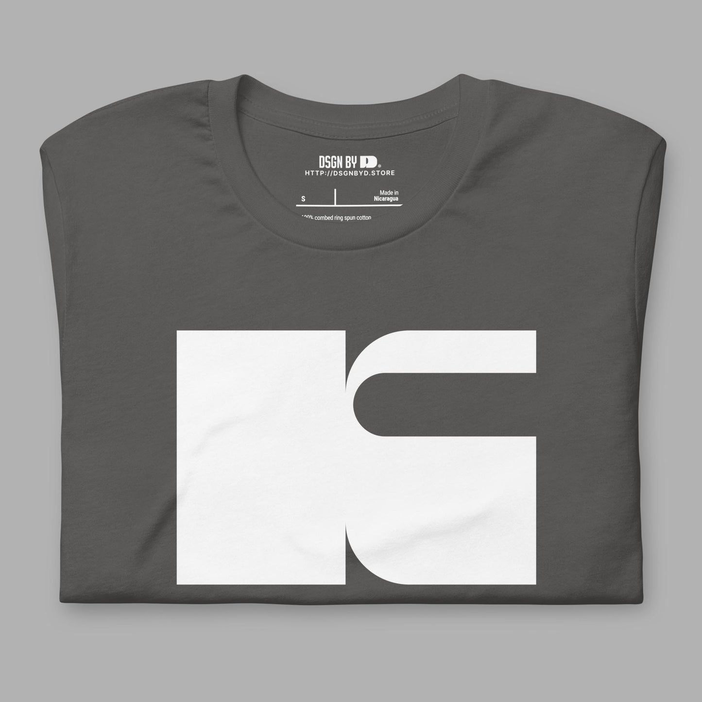 A folded grey cotton unisex graphic tee with letter K.