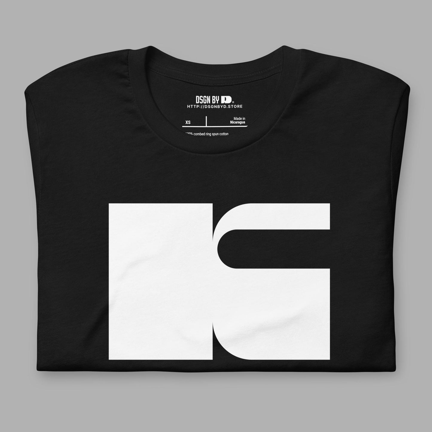A folded black cotton unisex graphic tee with letter K.