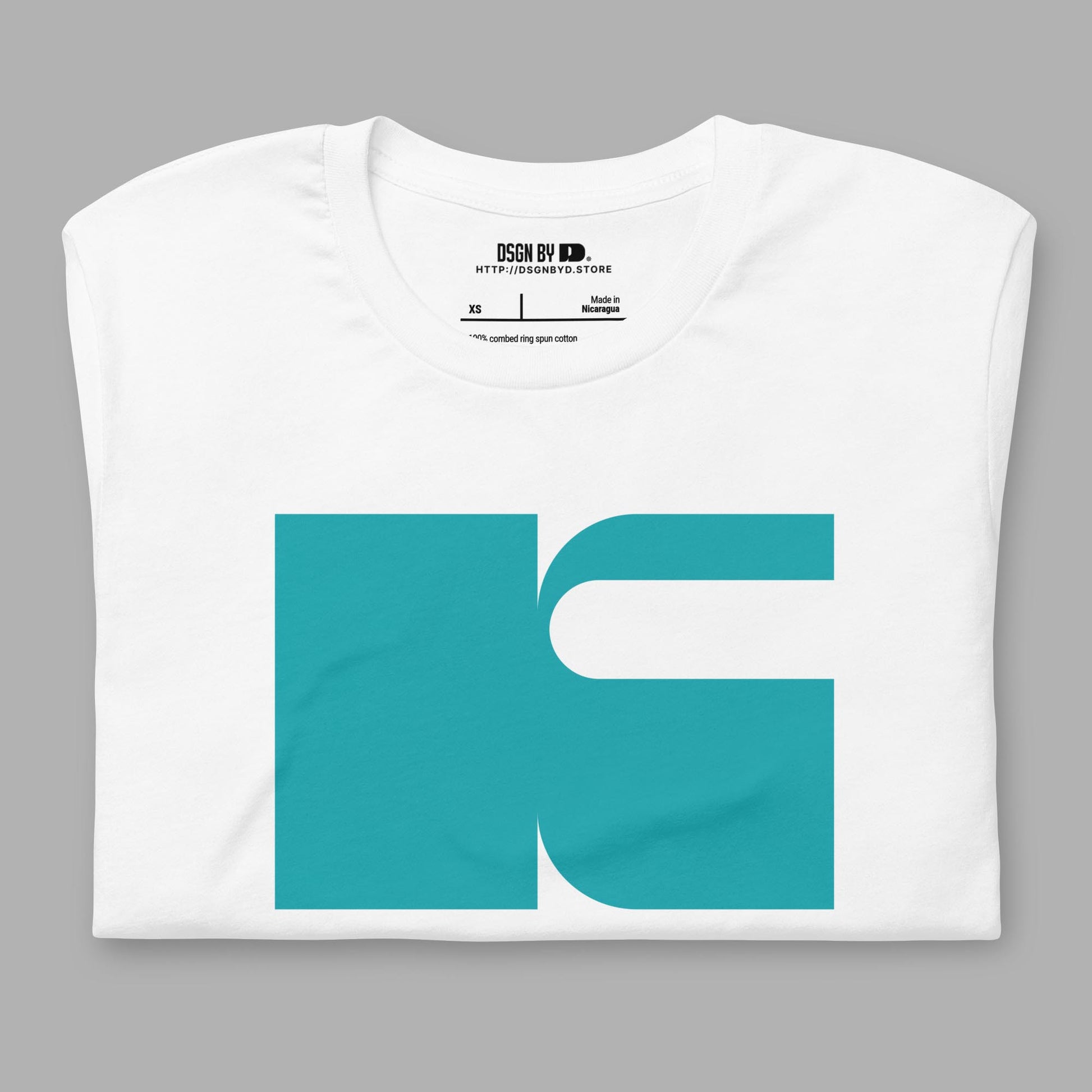 A folded white cotton unisex graphic tee with letter K.