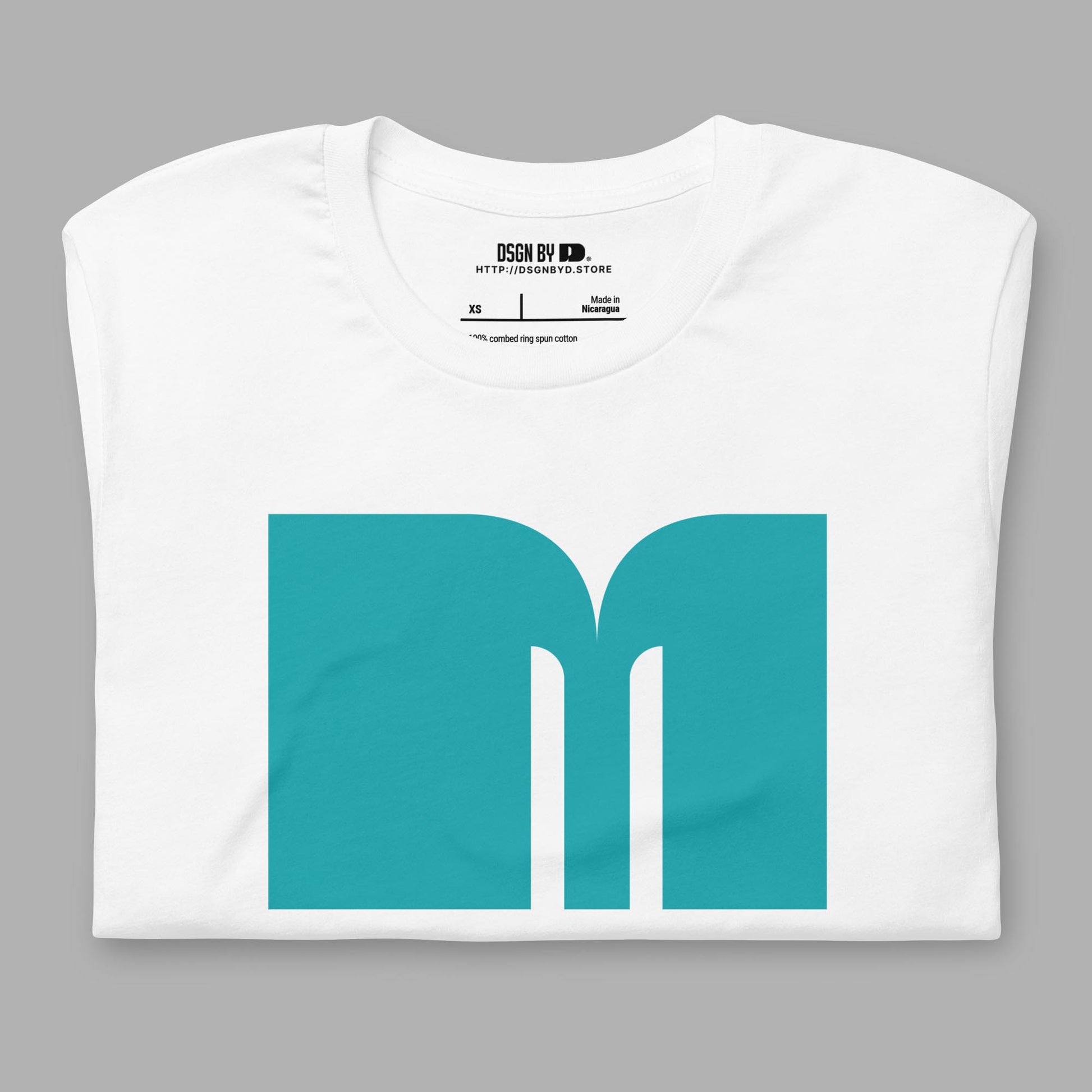 A folded white cotton unisex graphic tee with letter M.