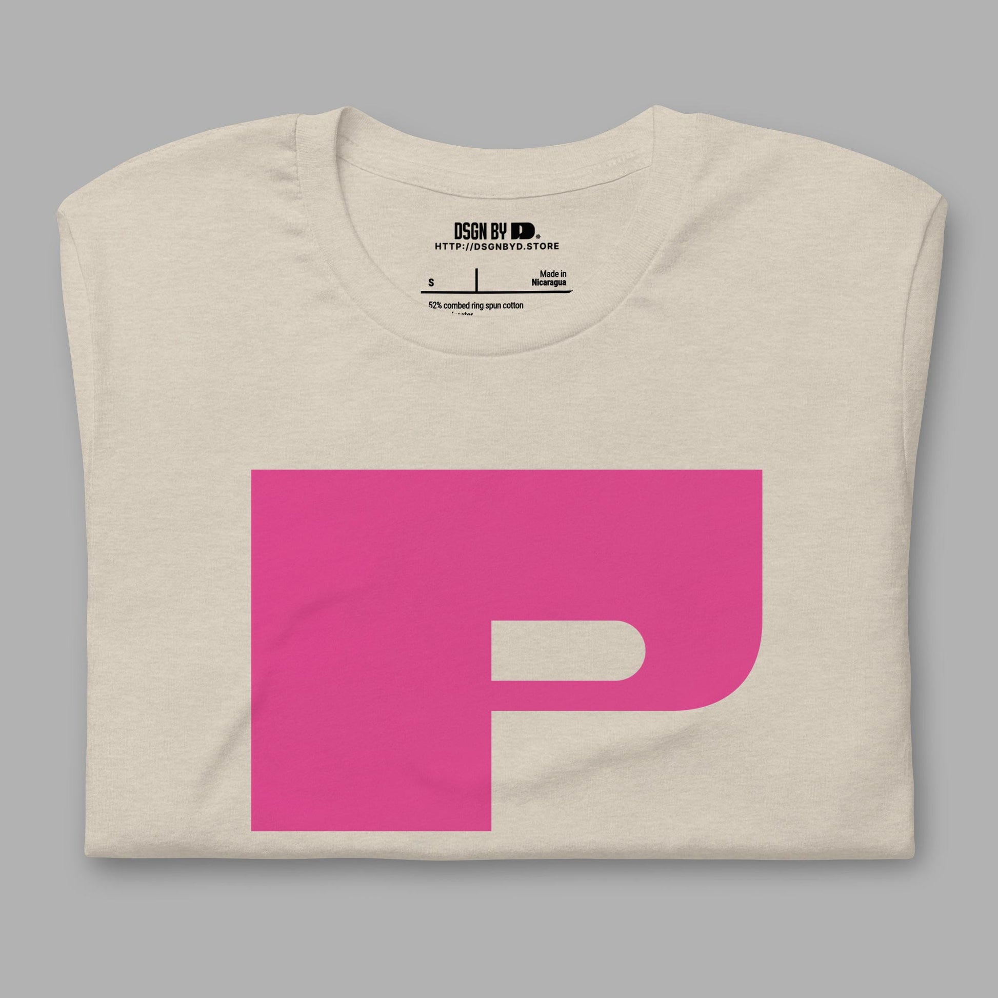 A folded beige cotton unisex graphic tee with letter P.