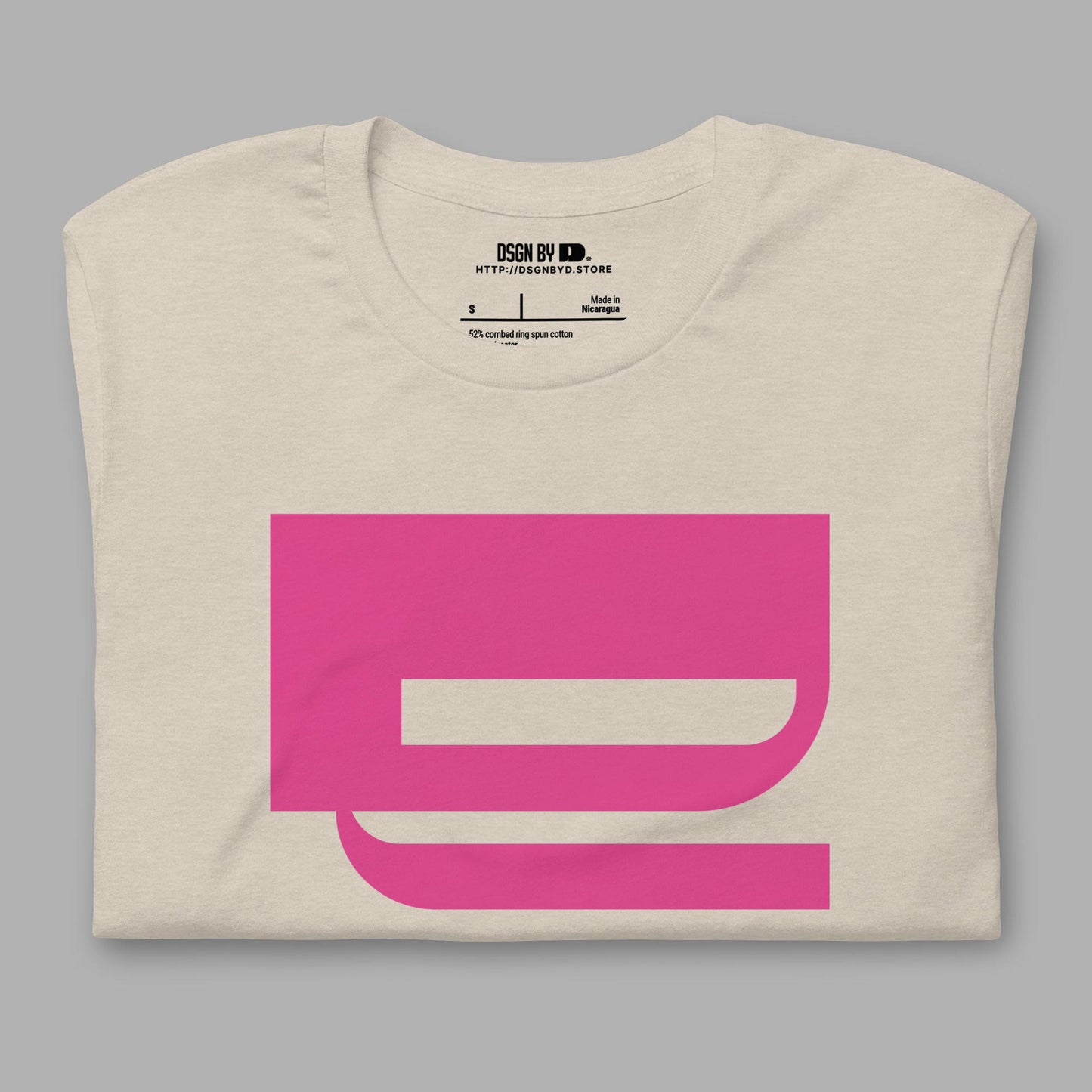 A folded beige cotton unisex graphic tee with letter Q.