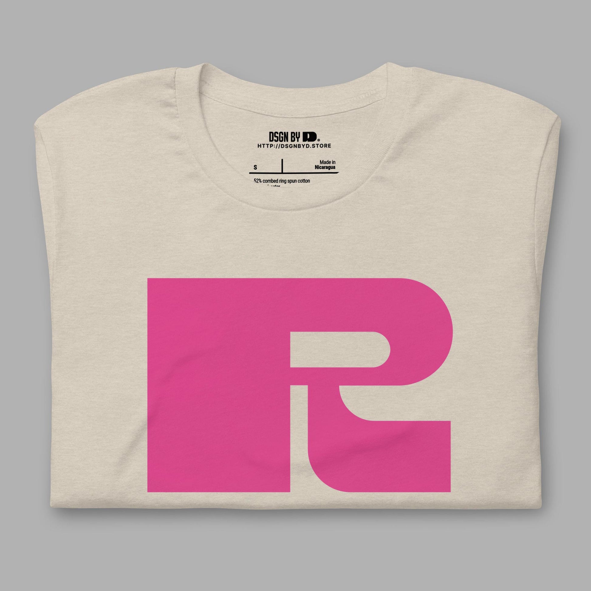 A folded beige cotton unisex graphic tee with letter R.