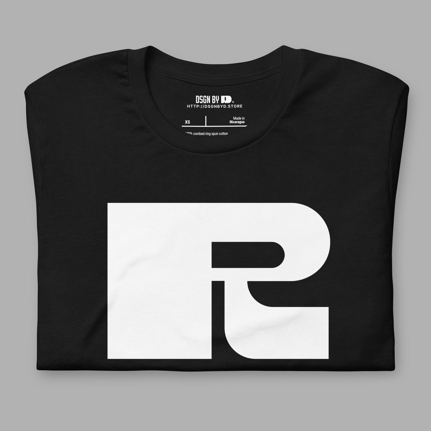 A folded black cotton unisex graphic tee with letter R.