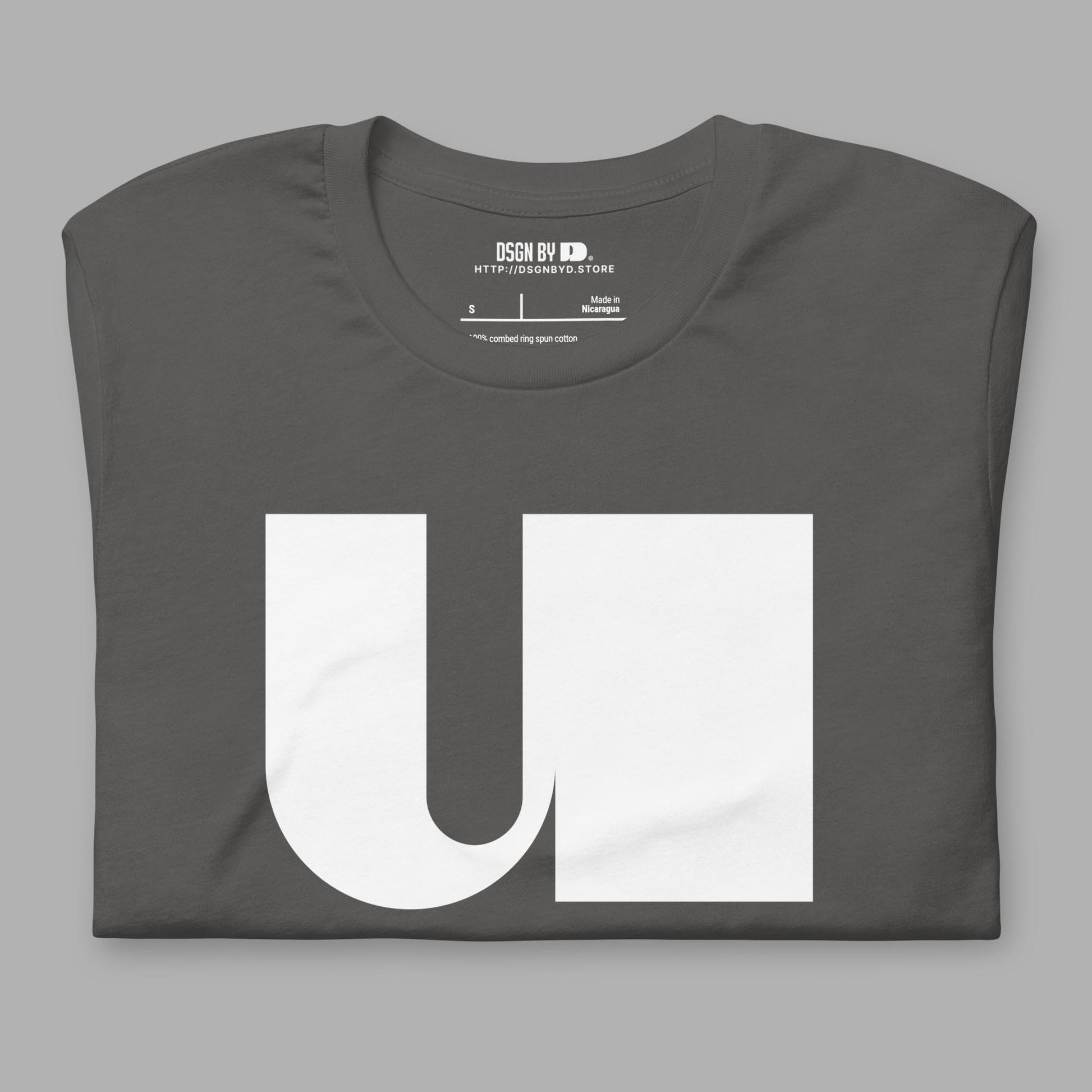 A folded grey cotton unisex graphic tee with letter U.