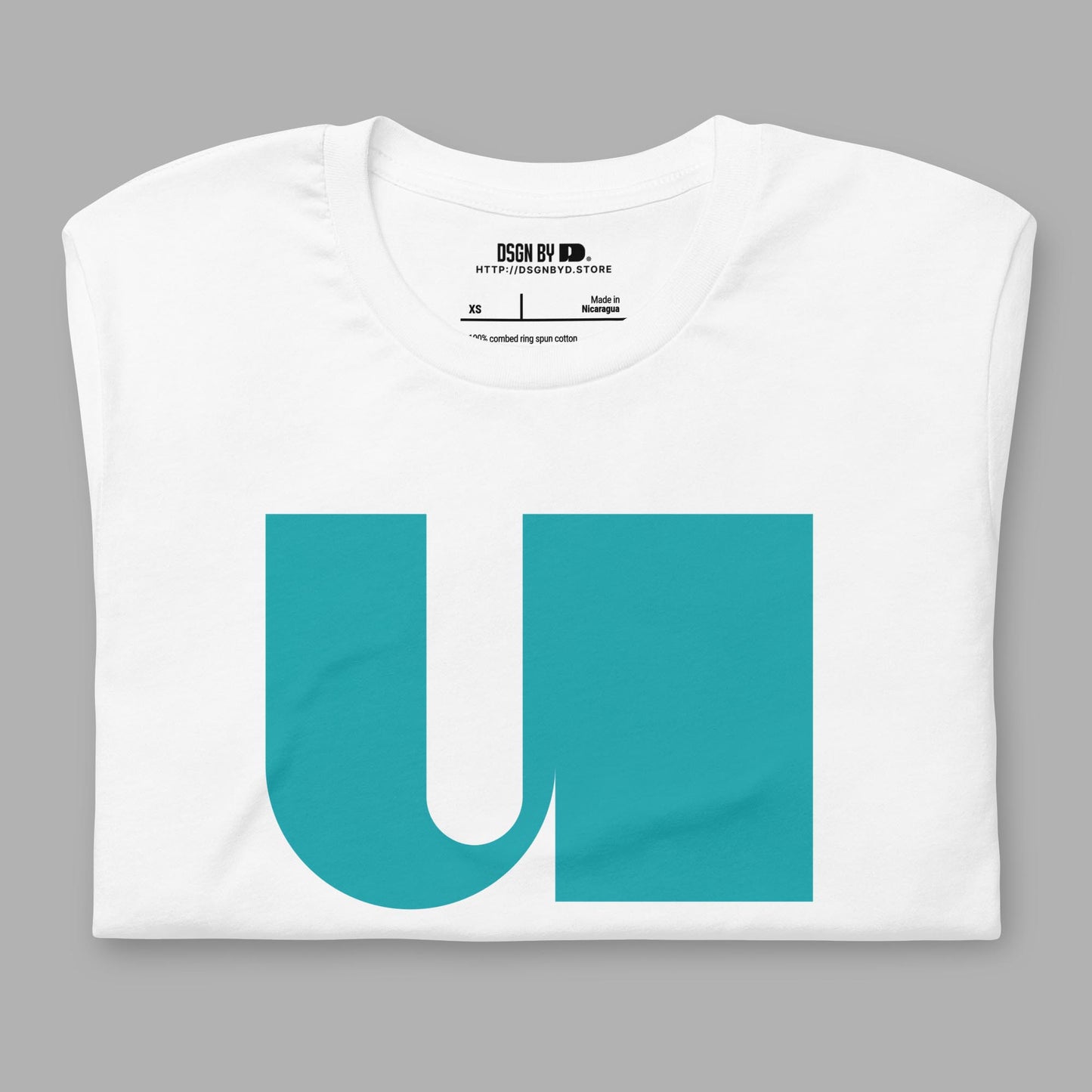 A folded white cotton unisex graphic tee with letter U.