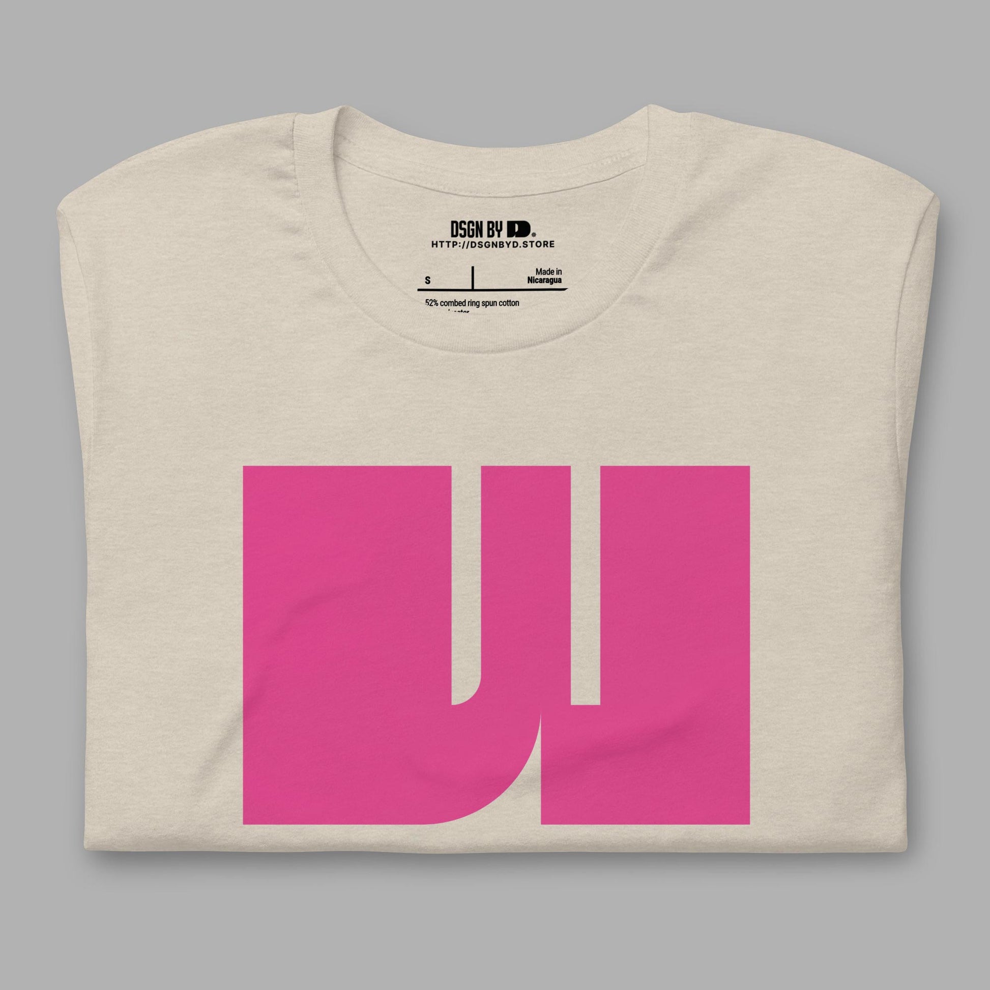 A folded beige cotton unisex graphic tee with letter W.